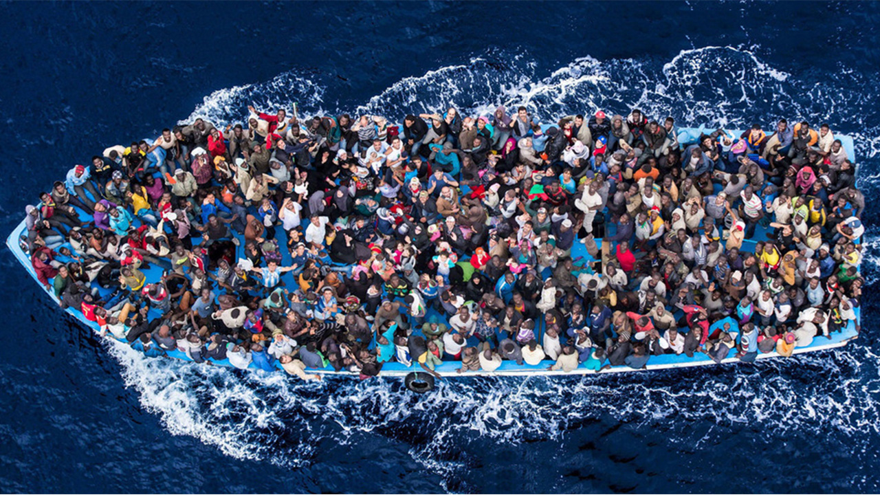 Refugees crowd on a boat off the Libyan coast