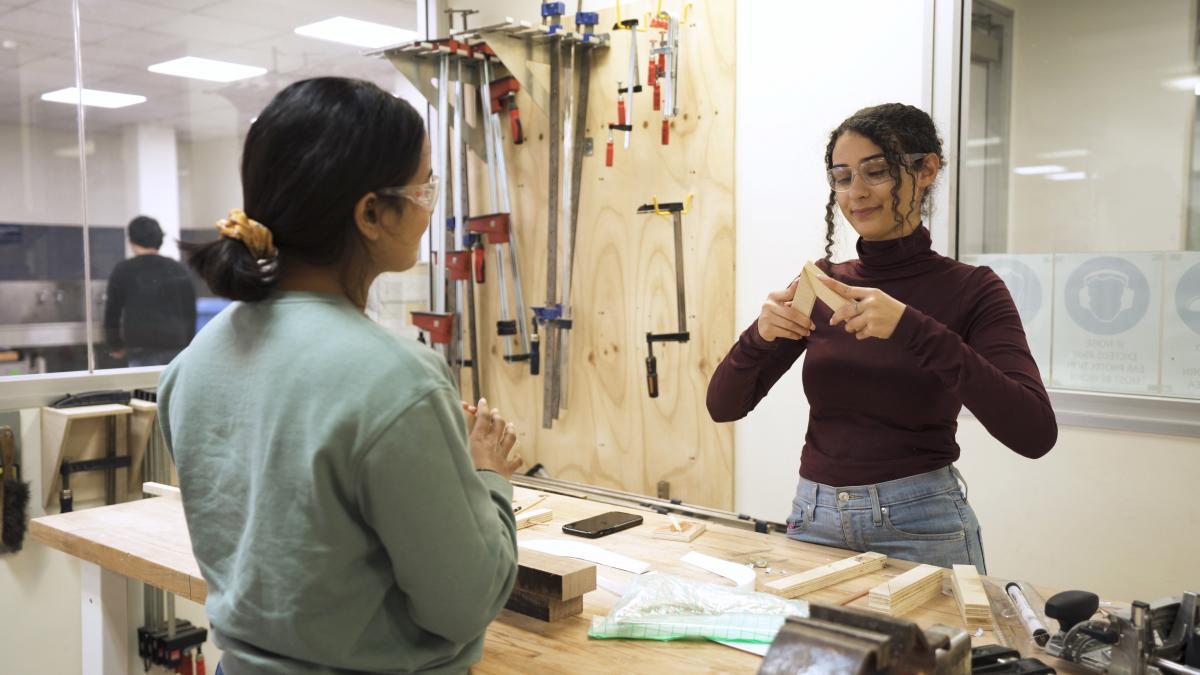 photo of two young people in a workshop making things