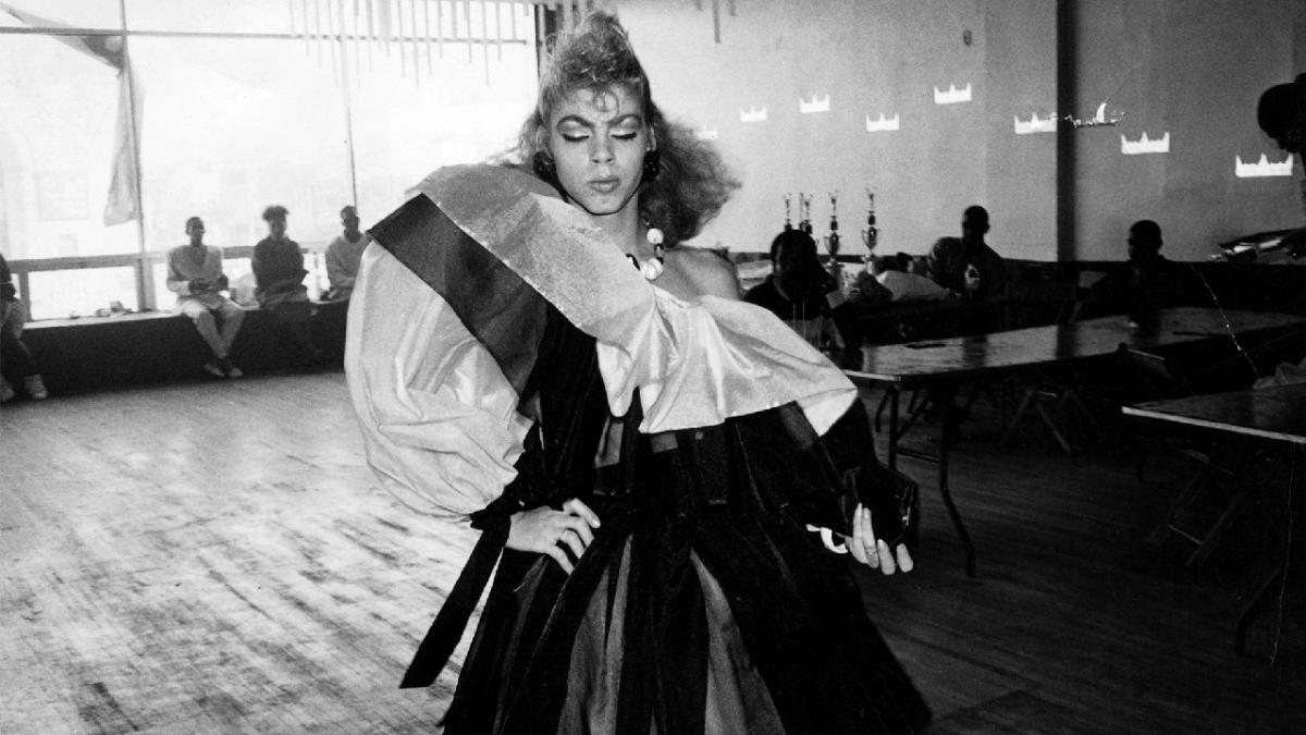 Photo of person in dress inside a hall