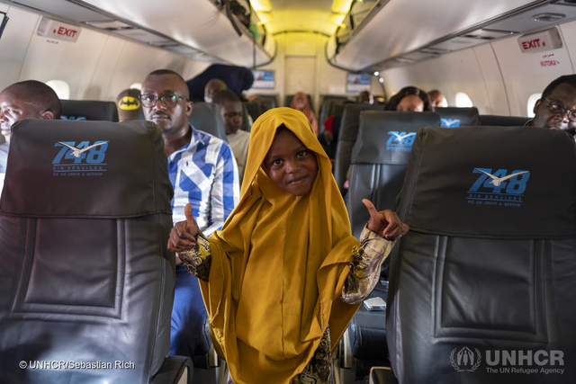 photo of a young girl inside a plane